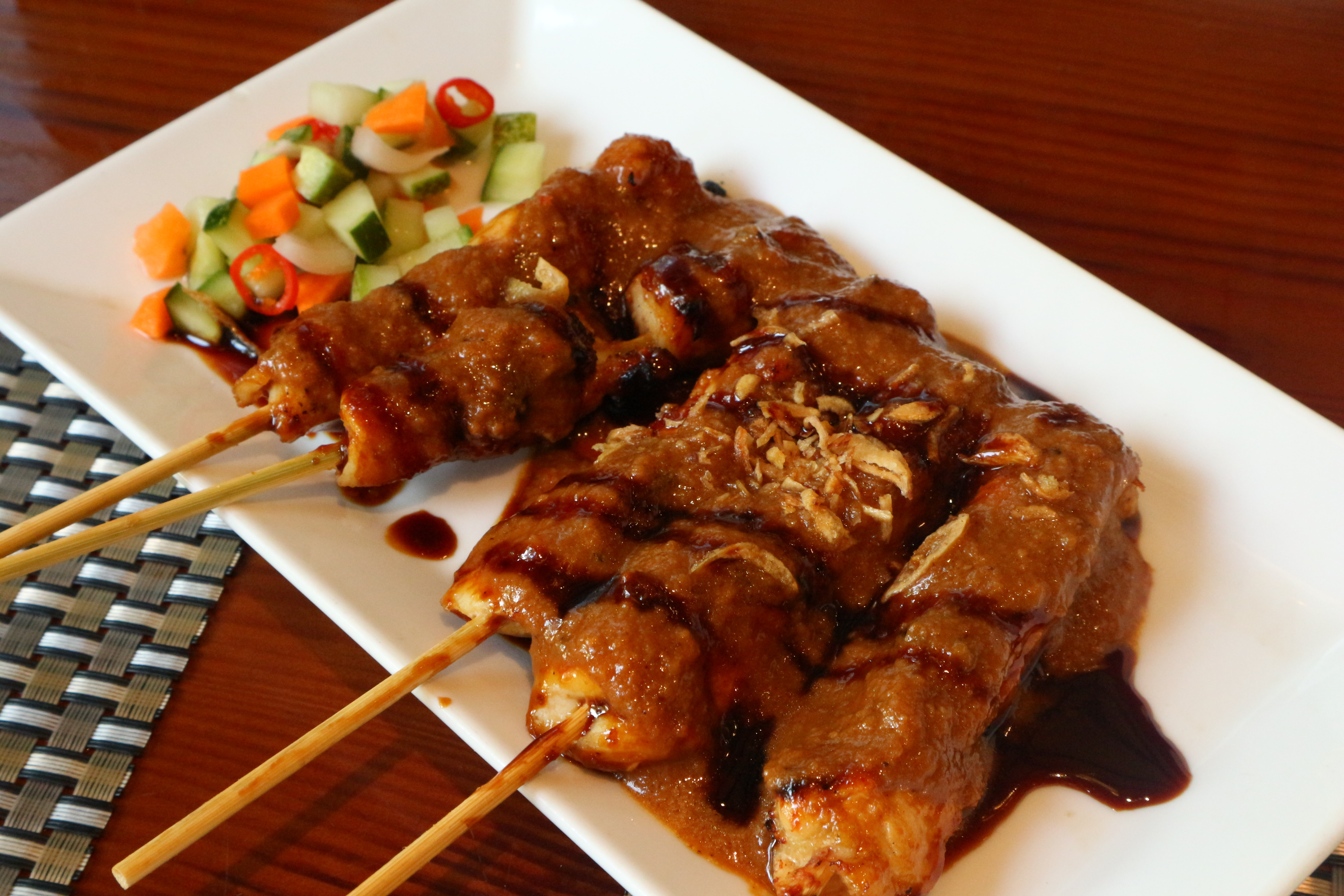Chicken satay skewers representing a first job and a journey of
